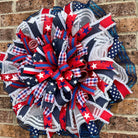 Queen Ann Patriotic Wreath – Star-Spangled Summer Beauty Decorative wreath with American flag patterns on a brick wall background